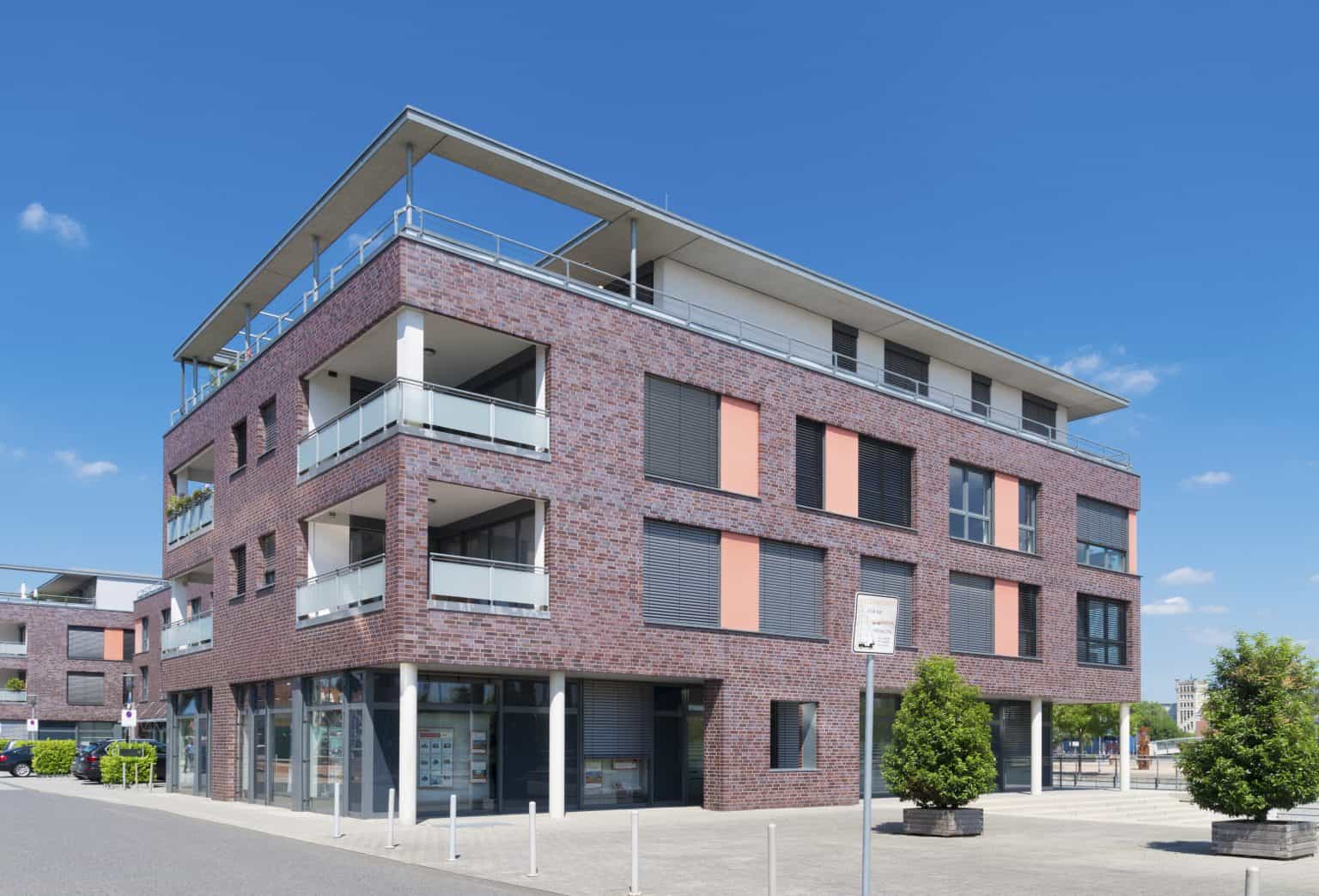 Modern multi-story residential building with brick façade and spacious balconies, located in Rochester, NY. Ideal for property management, apartments, and rental services.
